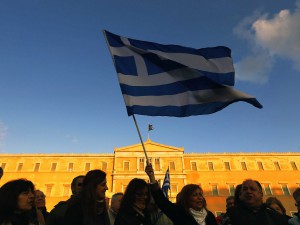 People wave Greek flags in front of the parliament during an anti-austerity pro-government demonstration in Athens February 15, 2015. 